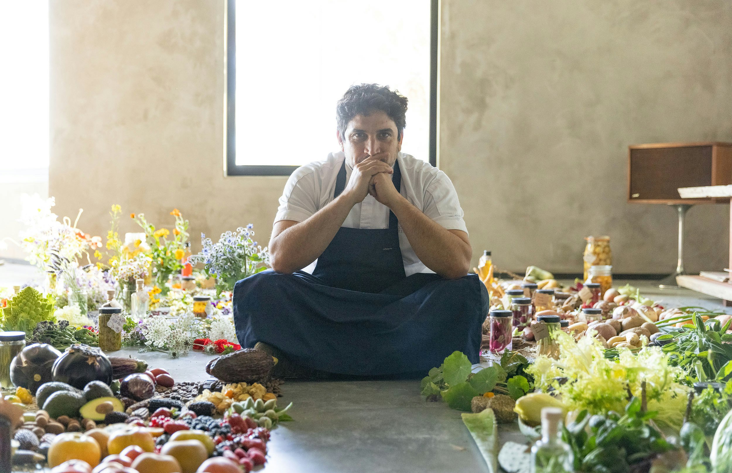 Mauro Colagreco sits with produce from his restaurant Mirazur