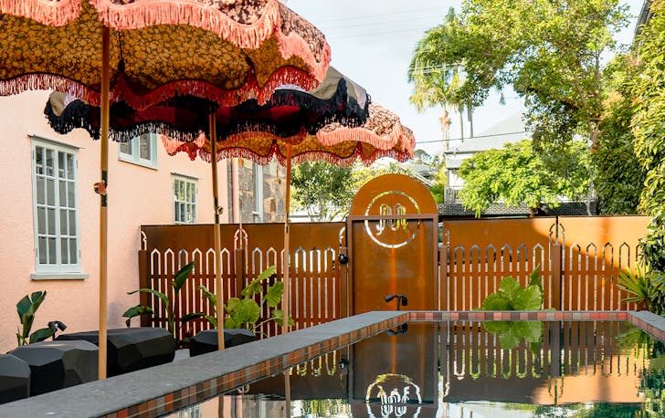pool with fabric umbrellas