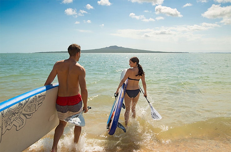 A couple going into the surf, Mission Bay Watersports