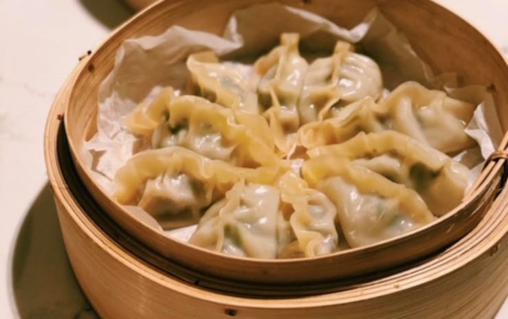 A bamboo basket filled with momo dumplings.