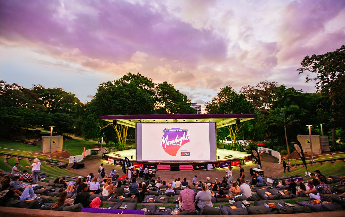 an outdoor ampitheatre facing a large screen