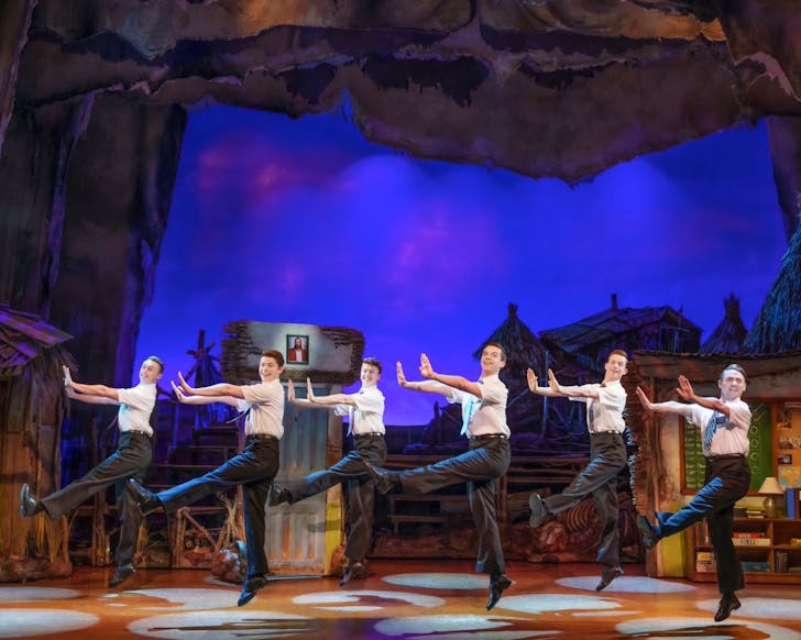 A view of the stage during the Book of Mormon musical. This moment features six mormon boys dancing.  