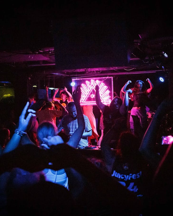 Duo Body Ocean rock a Morning People rave in a dark room with purple and pink lighting.