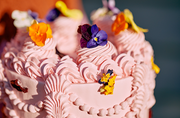 A close up of a cake and bright pink piping.