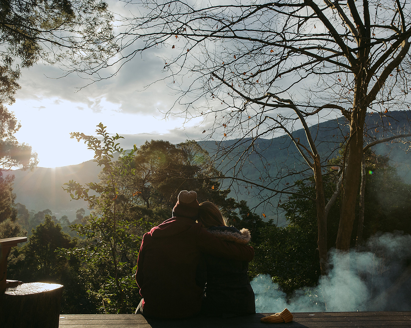 A couple have a cuddle while looking out at the view.