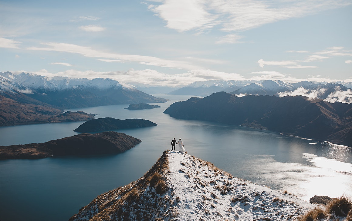 A couple stands atop Coromandel Peak by Mountain weddings
