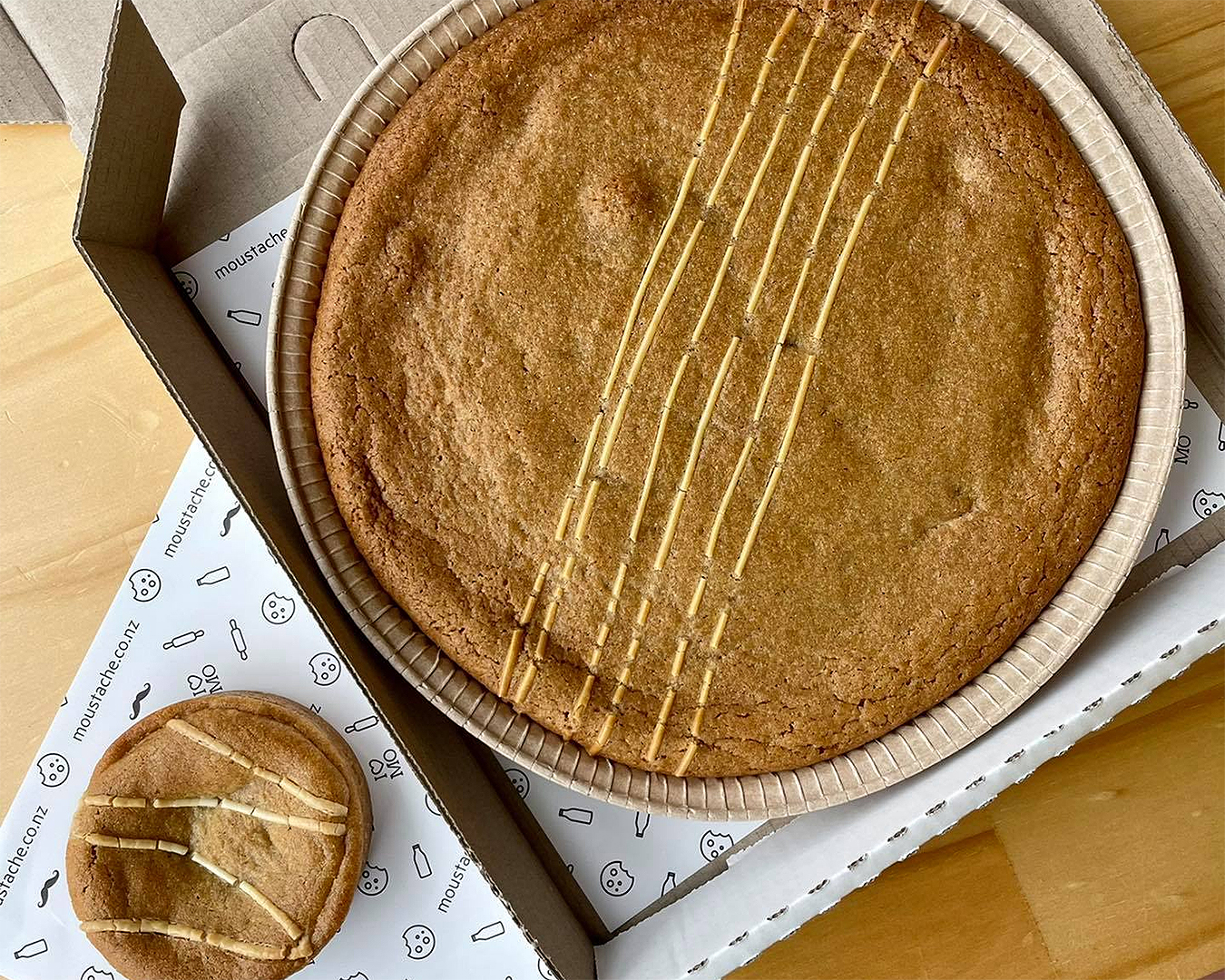 The massive Caramilk cookie pie cake alongside its regular cookie pie sized sibling.