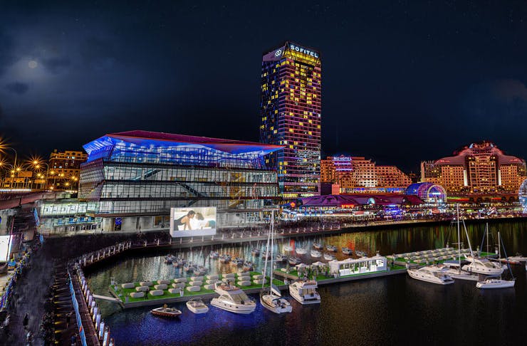 A render image of Darling Harbour in Sydney, complete with a floating cinema. 