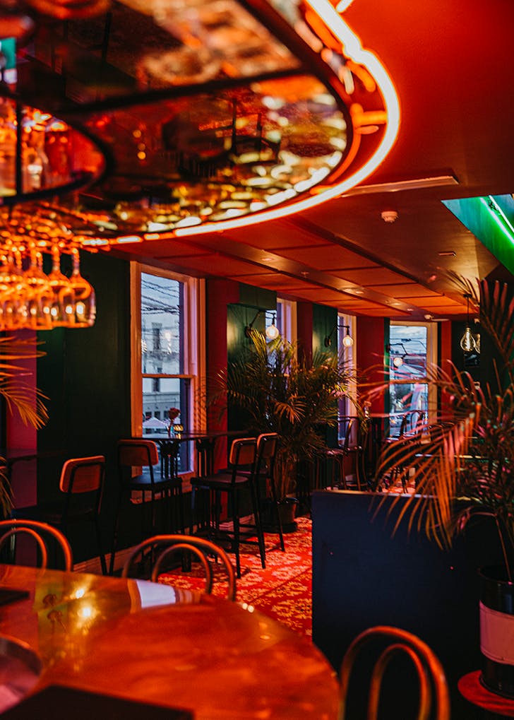A pub's dining room covered in red velvet.