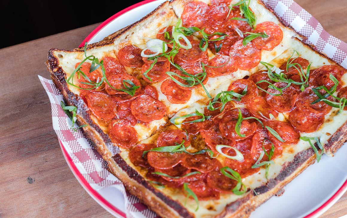 a square pizza topped with pepperoni