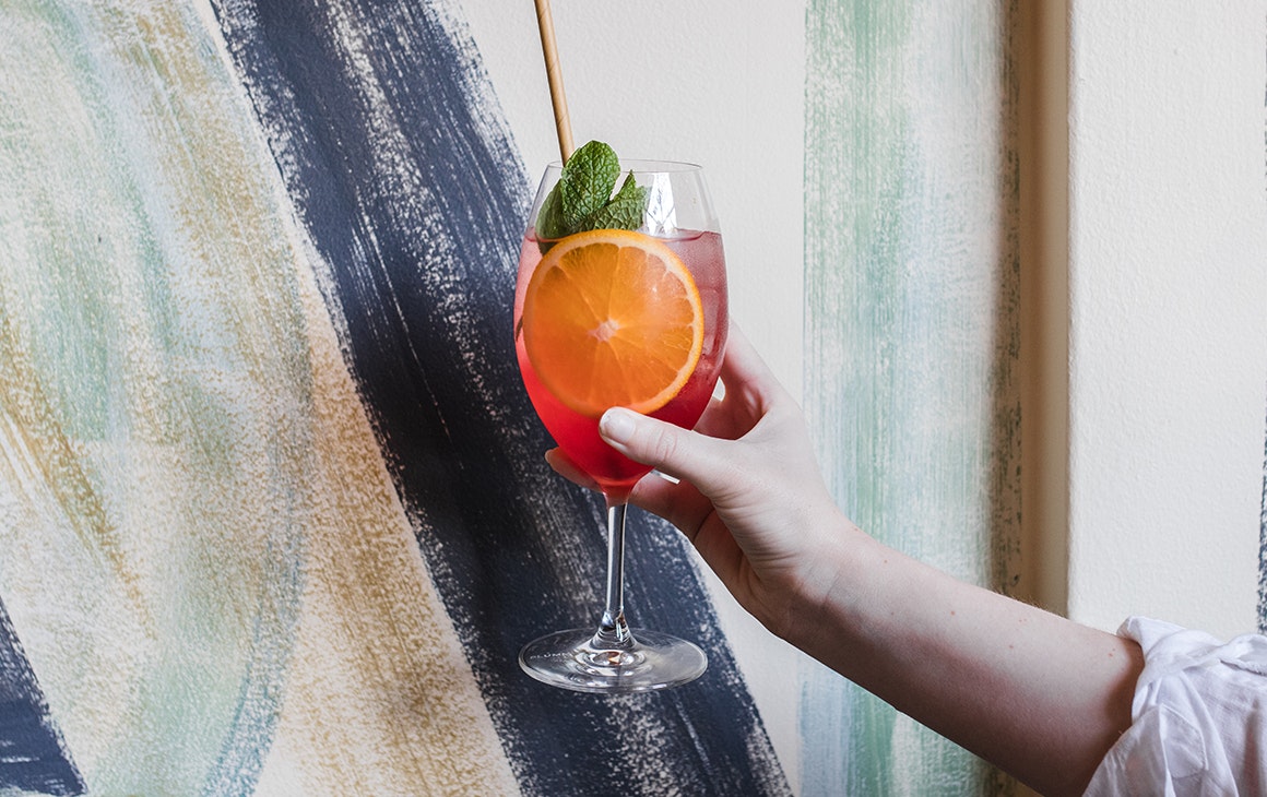 a hand holding a spritz