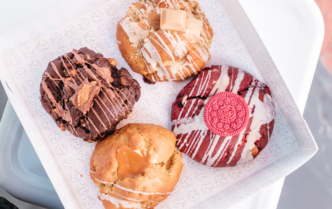 top down view of four cookies in a box