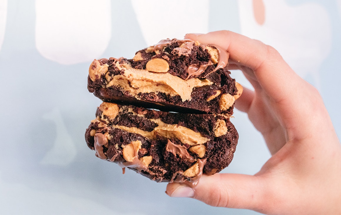 a peanut butter and chocolate chip cookie in half