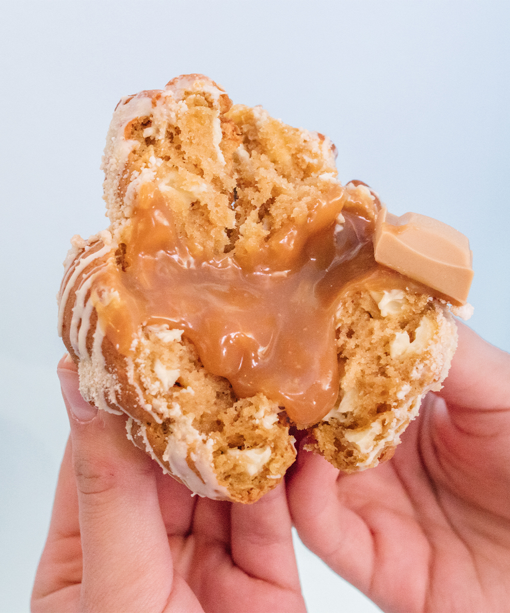 a cookie pulled in half, with caramel inside