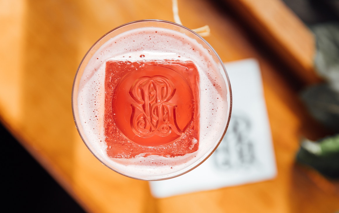 a cocktail with a patterned ice cube 