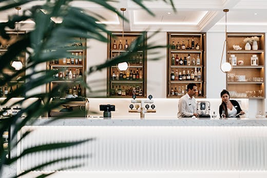 The sleek, white interior and gleaming bar of Ms Margot in Surfers Paradise.