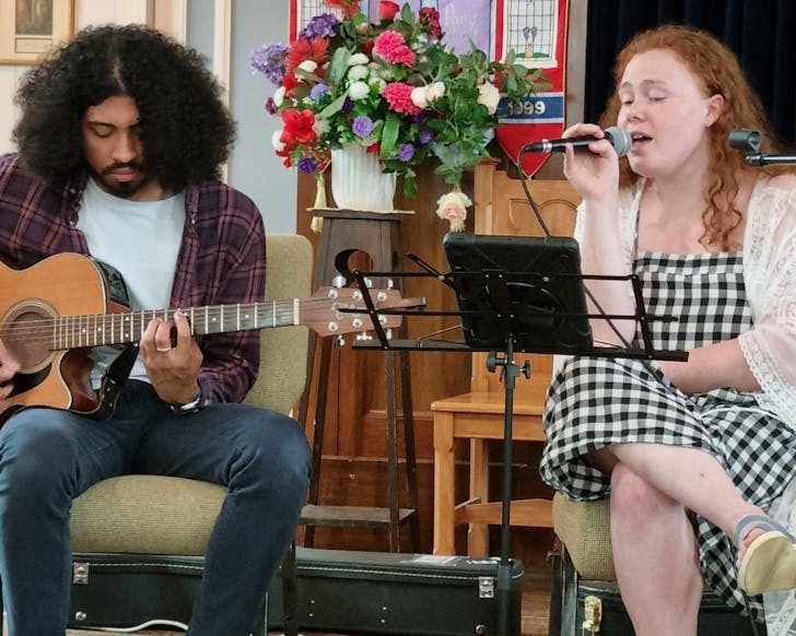 Two people perform live music.