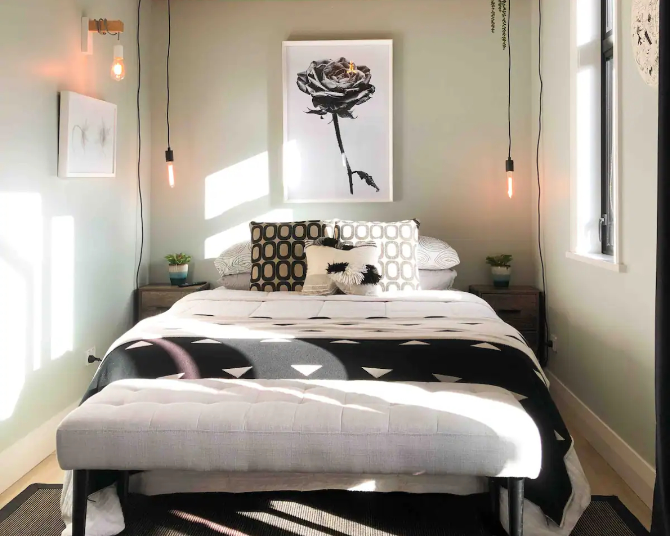 The lush bedroom at the Mount Victoria Studio is decked out in stylish, monochromatic decor 