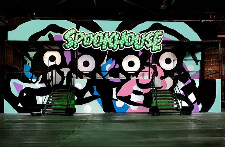 a painted neon mural that says SPOOKHOUSE
