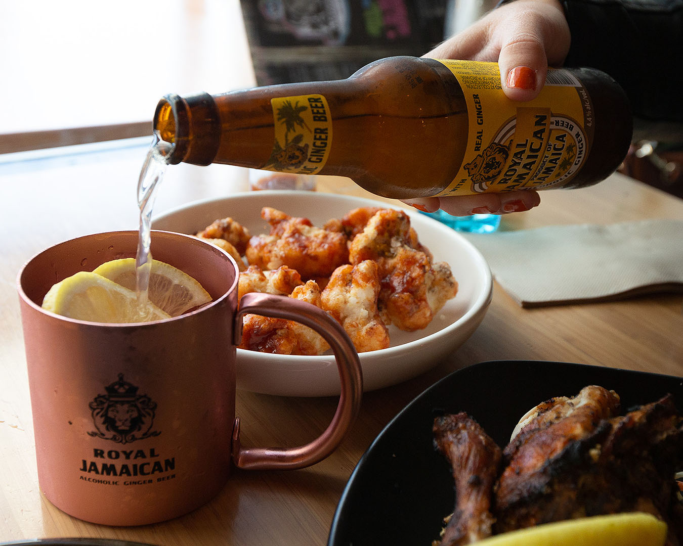 Someone pours alcoholic ginger beer at Nanny's Eatery in Kingsland.