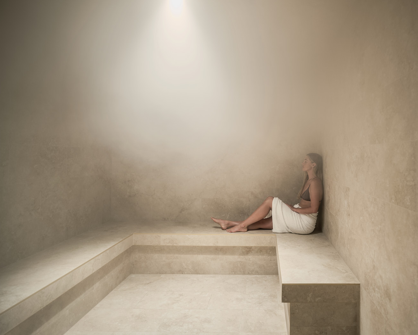 woman sitting in steam room