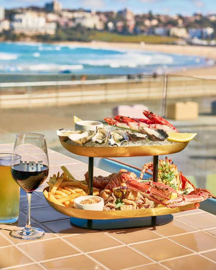 north bondi fish seafood tower and glass of wine for father's day with an ocean view