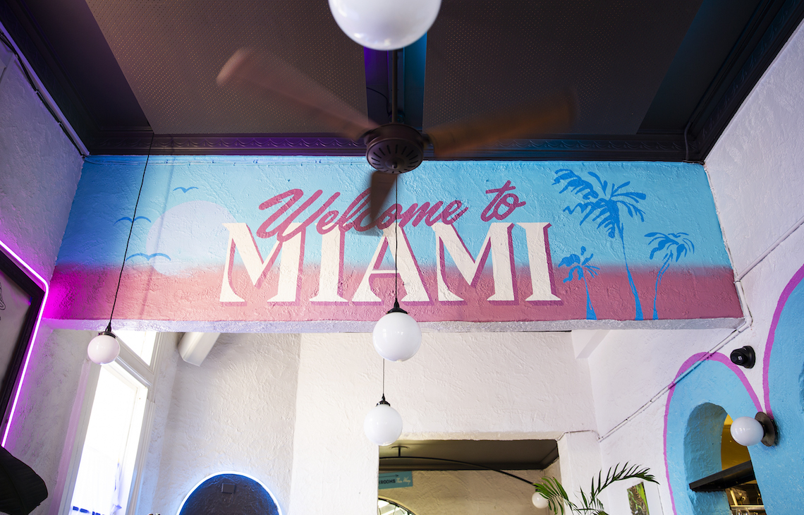 Interior of Neon Palms with Welcome To Miami sign