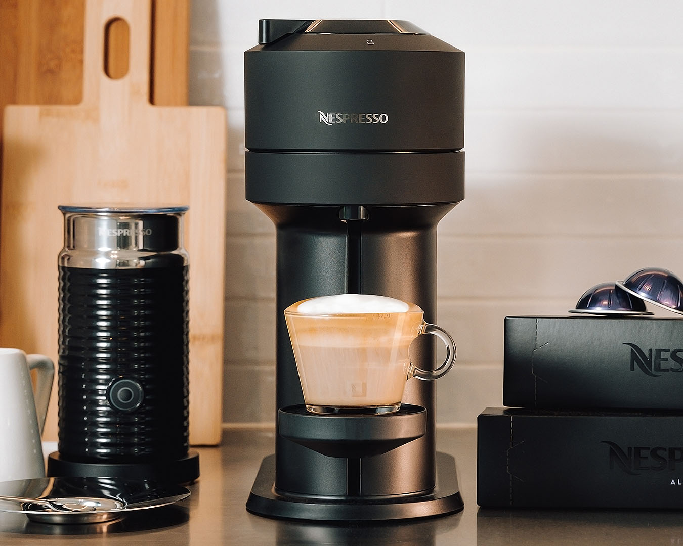 A small, sleek coffee machine with a cup full of mouthwatering coffee. 