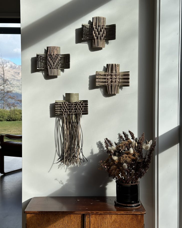 Some of the woven artworks of 'Shift into Neutral' hanging on a white wall in a modern home.
