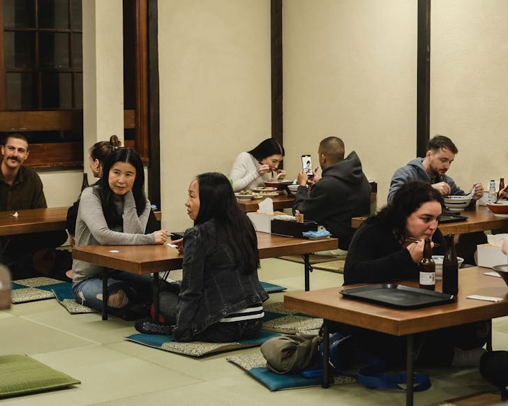 People sit on the floor at Ramen Auru, a new restaurant in Sydney