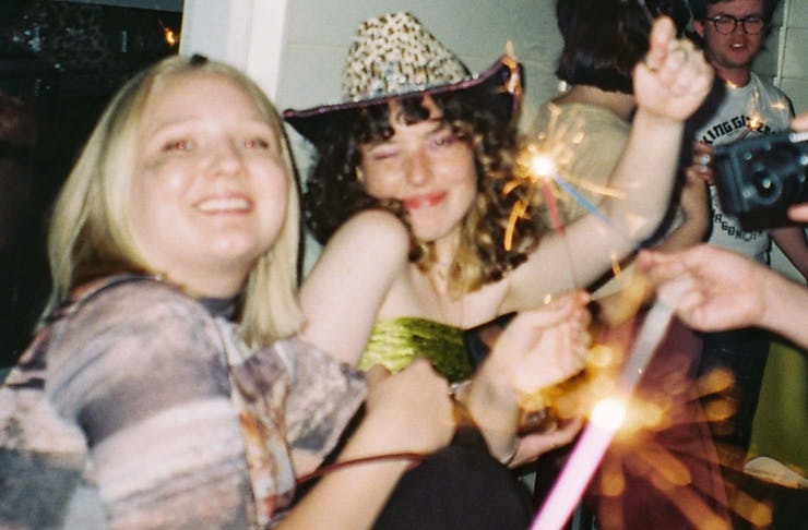 people at a party holding sparklers