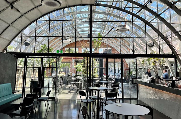 a restaurant with a curved glass ceiling