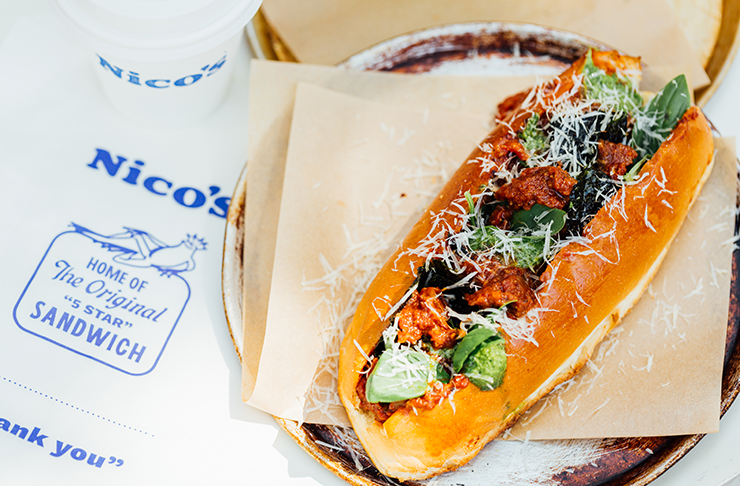 A large meatball sub covered in Parmesan. 