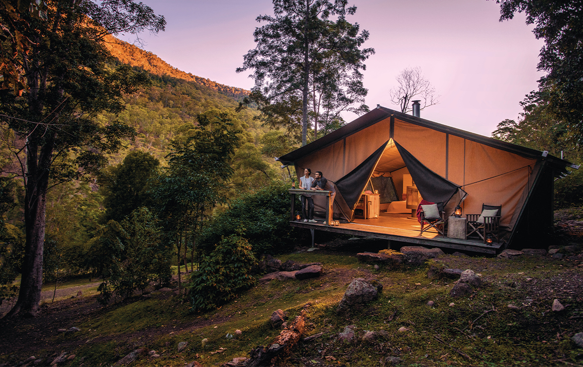 two people at a glamping tent