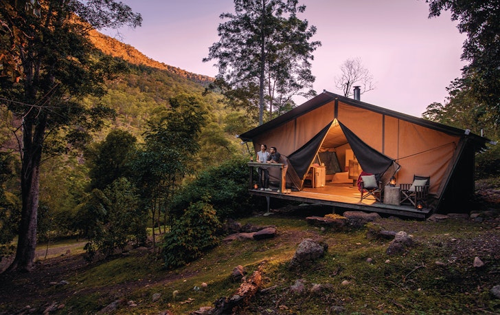 two people at a glamping tent