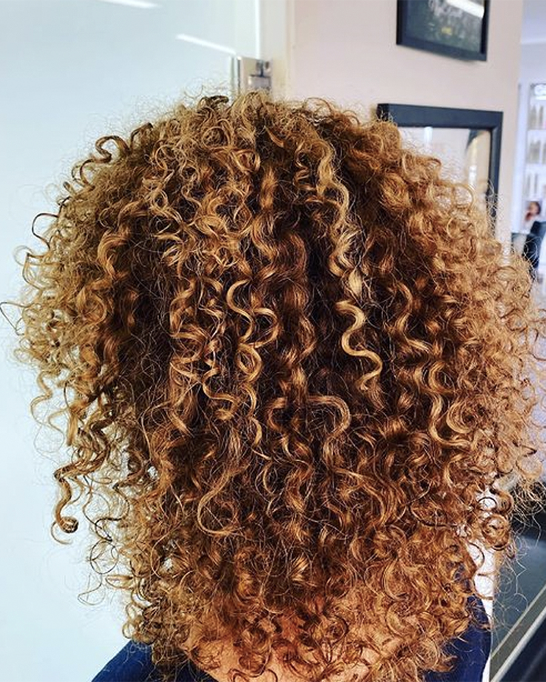 A woman with curly hair.