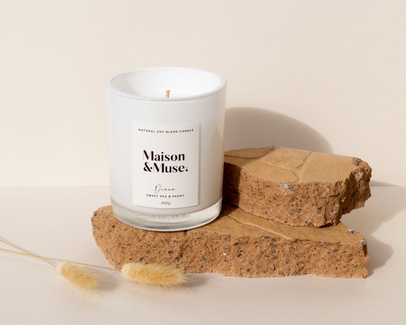 A Maison & Muse candle in scent 'Diana' is displayed looking sleek and luxurious