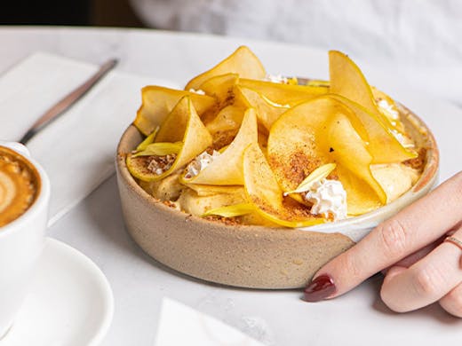 a smoothie bowl topped with apple slices