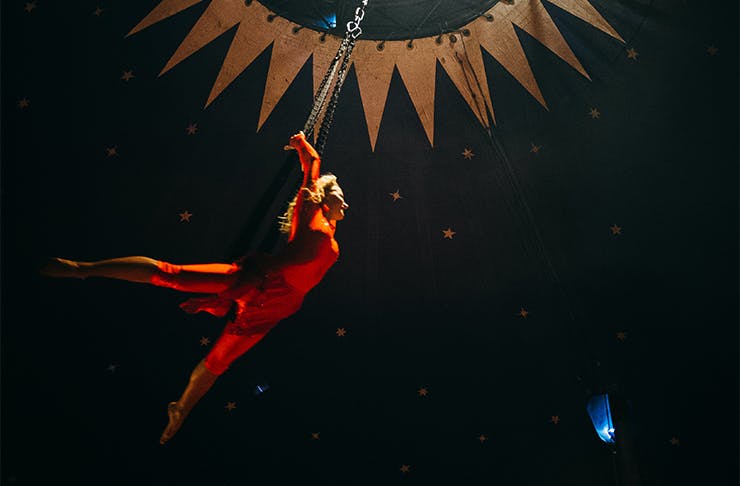 an acrobat in a red suit