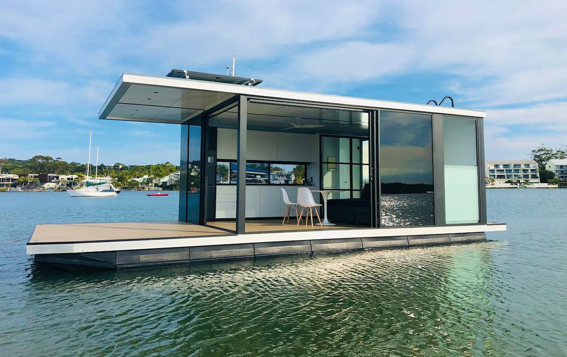 a small houseboat on calm water