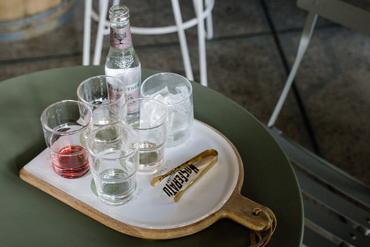a tasting paddle of gins with tonic