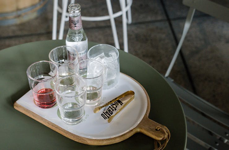 a tasting paddle of gins with tonic