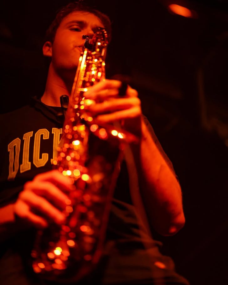 Conception Band's saxophonist under gold light belts one out in the darkness of Neck of The Woods.