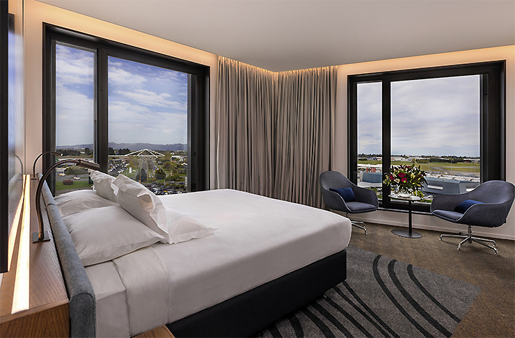 A well appointed room at the Novotel Christchurch Airport looks out onto the runway.