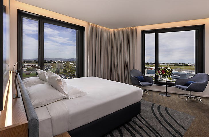 A well appointed room at the Novotel Christchurch Airport looks out onto the runway.