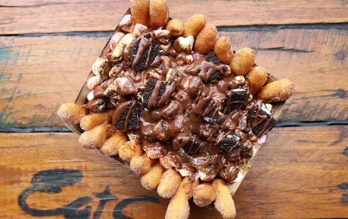 a box of doughnut fries topped with nutella
