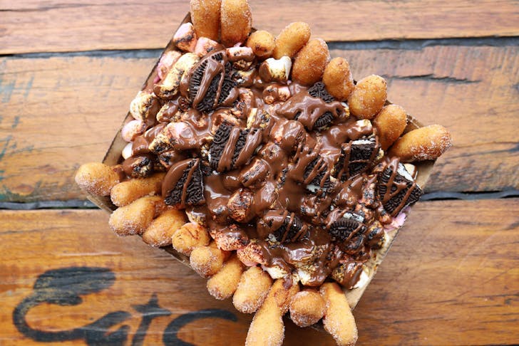 a box of doughnut fries topped with nutella