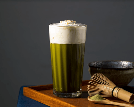 A nut-based milk tea placed on a wooden table.