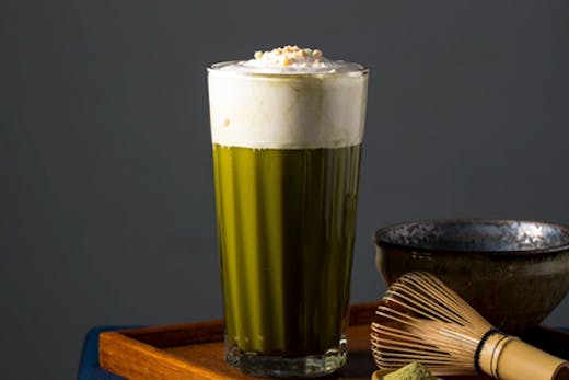 A nut-based milk tea placed on a wooden table.