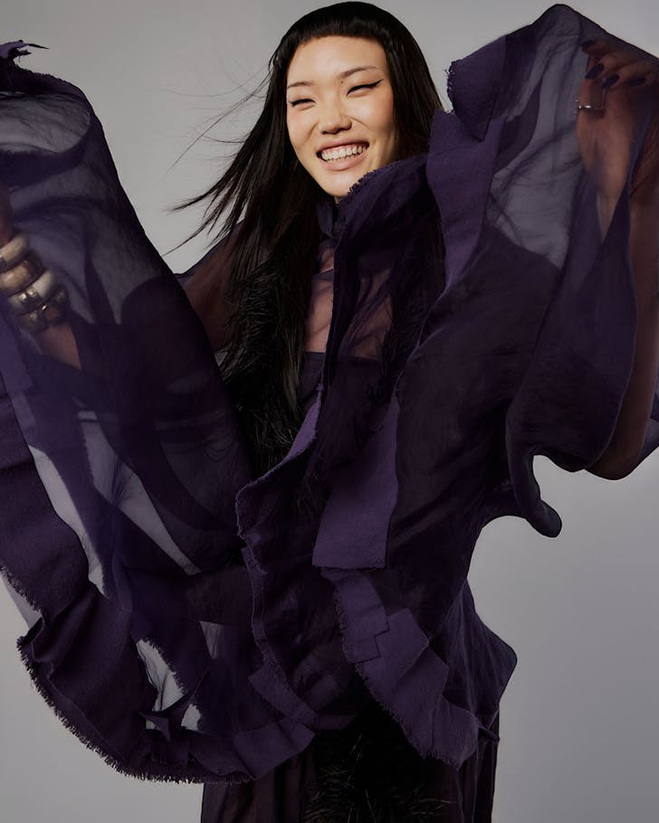 Model Sophie Song dazzles in a wavy midnight blue gown and cape by emerging designer Giulia Zigliani.
